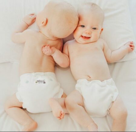 twins in night nappy on bed