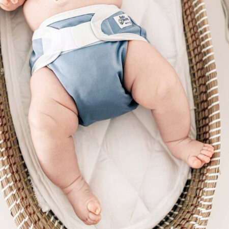 nappy cover in blue on baby laying down