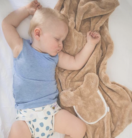 baby-lying-on-brown-baby-blanket