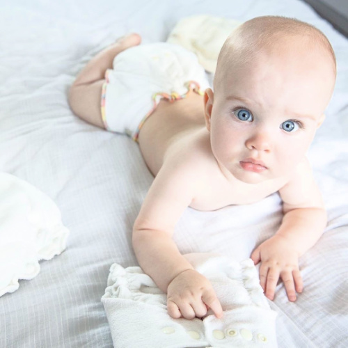 fitted nappy on cute baby with blue eyes