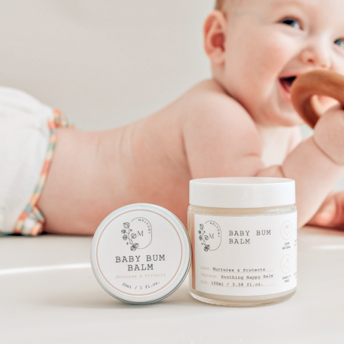 baby on tummy with melvory baby bum balm in front