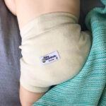 wool nappy cover on twins touching each other